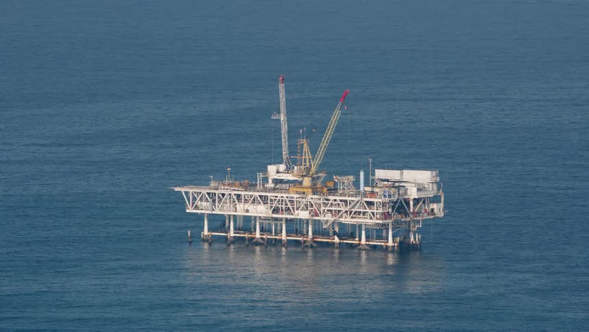An oil platform on the ocean during the day