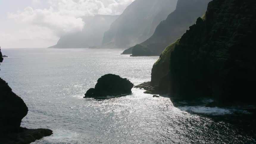 Waves crash onto the bottom of promontories along the coast