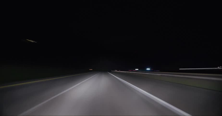 Time lapse view of cars driving on a highway at night