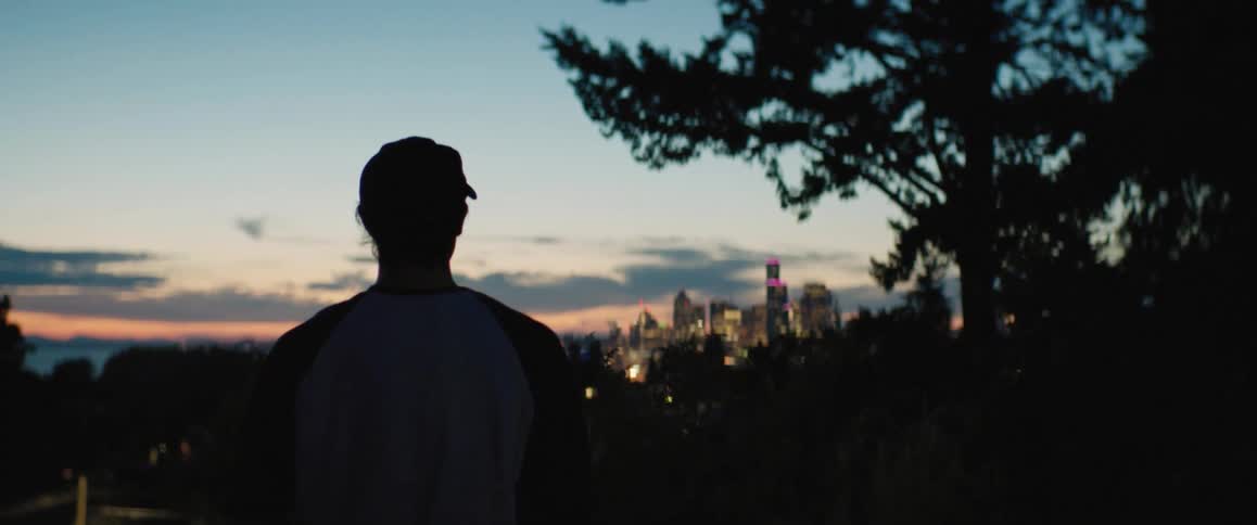 A man throws a ball on the hill top