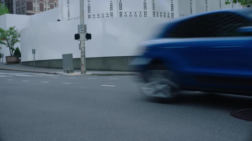 Cars are driving on a street in an urban city
