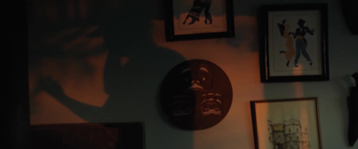 Mans shadow talking on smartphone reflected on wall at sunset