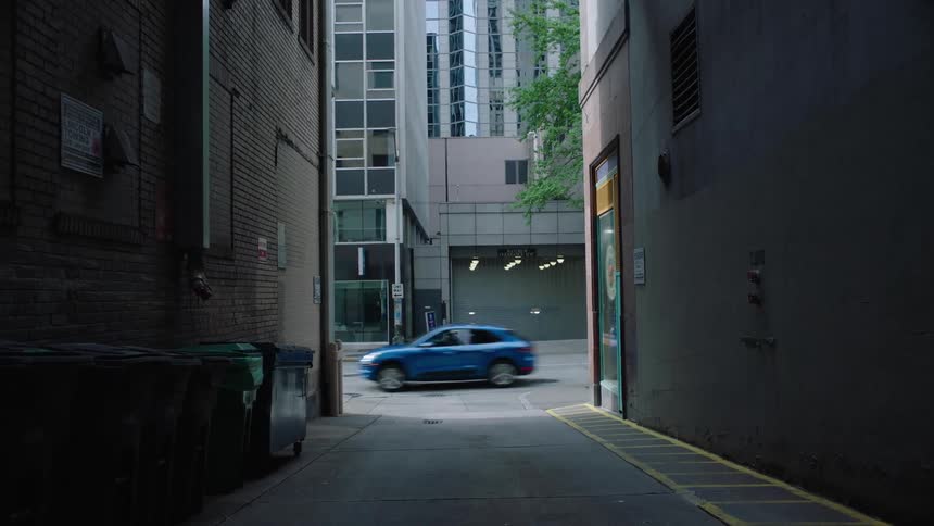 An alleyway between buildings in a metropolis during the day