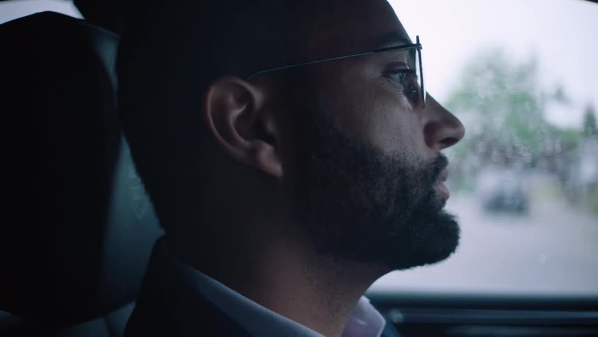 A man is driving in the rain