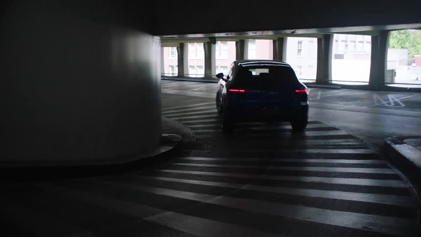A car is driving out of a parking ramp