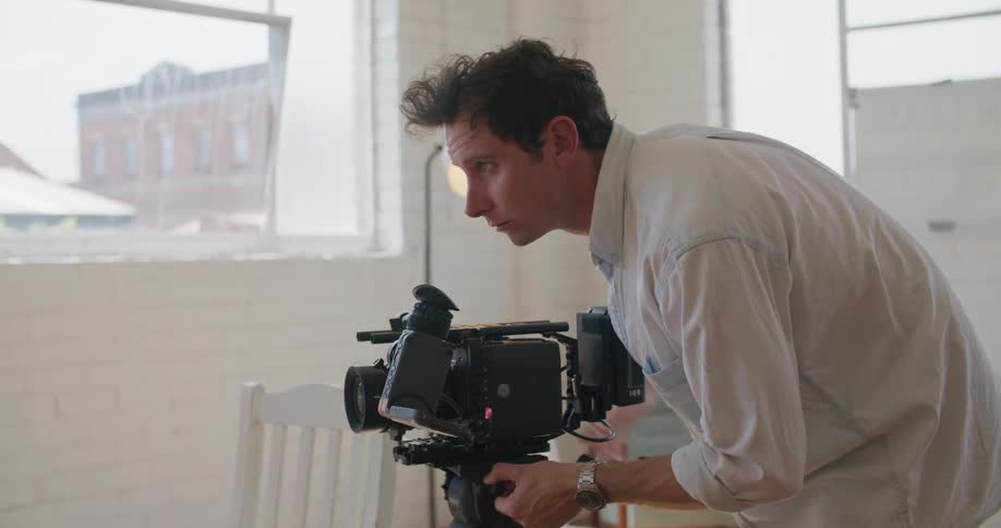 A man is filming with a video camera