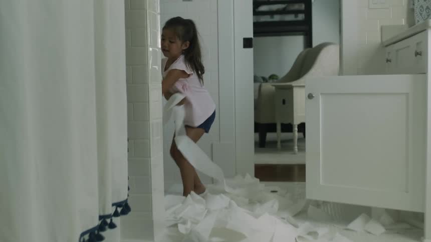 A child is making a mess in the bathroom