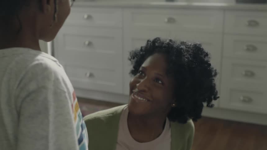 Mother smiles while discussing marker drawing on room wall
