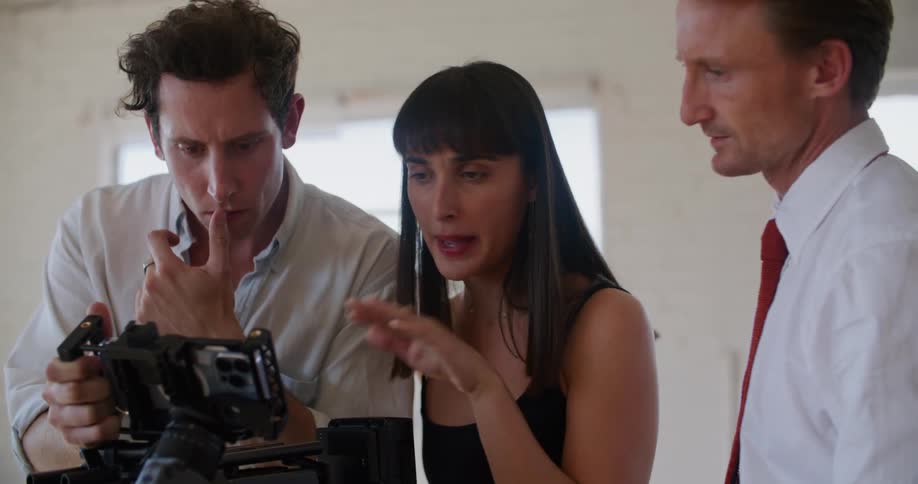 A group of people looking at a film camera
