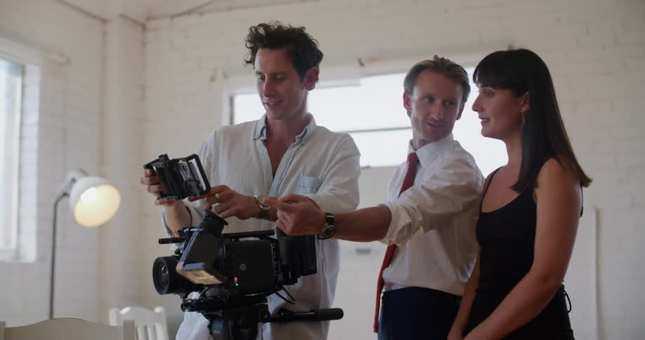 Three people looking at a camera