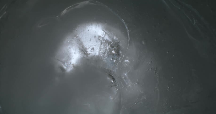 A solid substance with a shiny surface can be seen upclose in this surreal scene