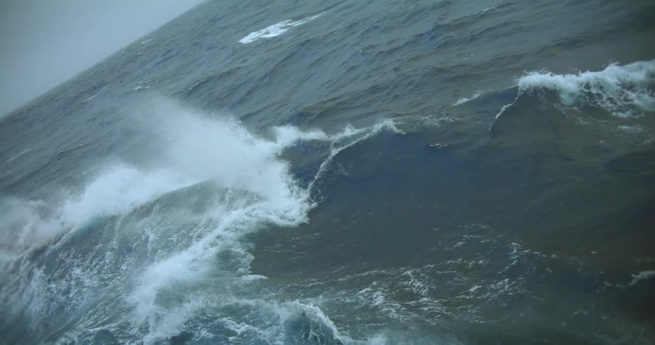 Huge waves are forming and splashing in ocean water