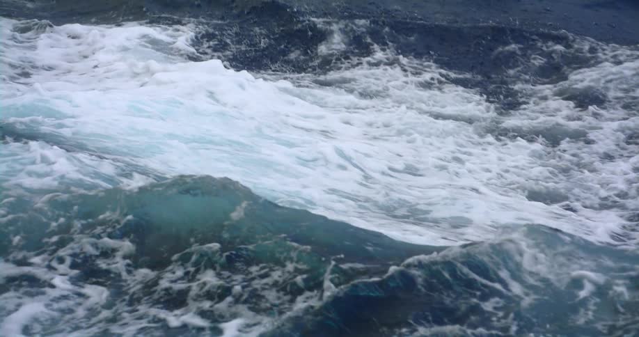 Rough water is splashing and foaming as it waves and rolls