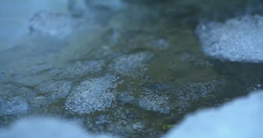 Chunks of ice float down a small stream