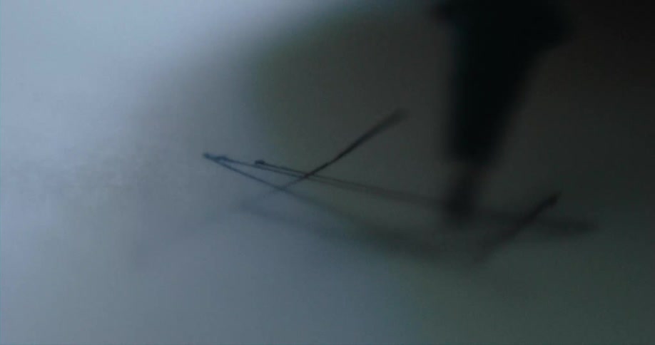 A box drawn on paper is filled with a series of diagonal lines made by pen