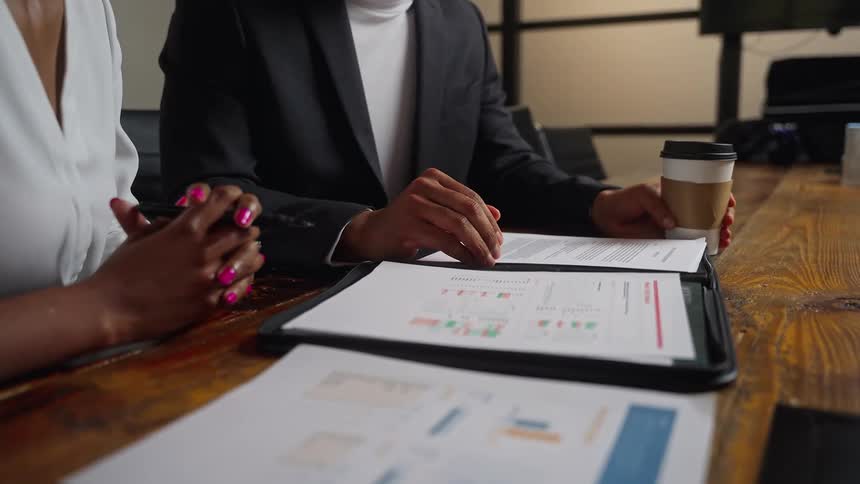 Colleagues go over paperwork in a conference room