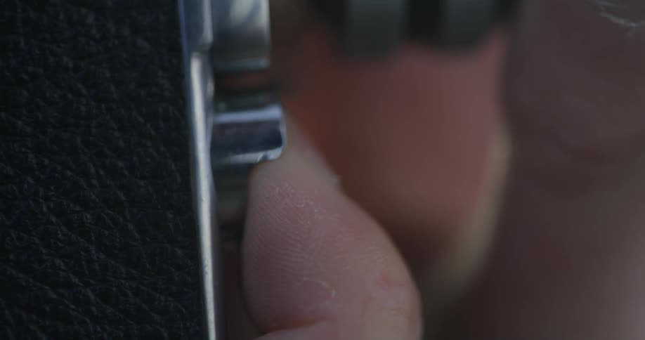 A person pressing a button on a camera