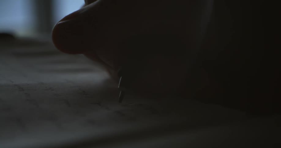 A person is writing in a notebook