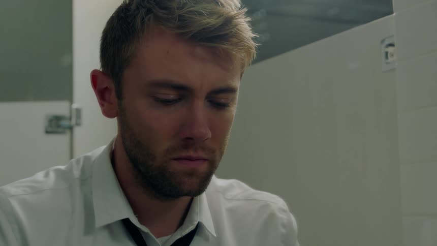 A man looks nervous in the mirror