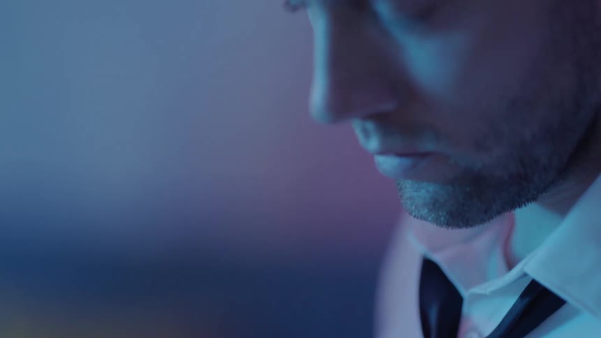 Close up view of a man standing in a room is displayed