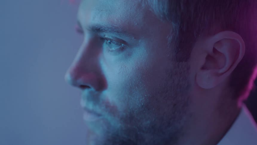 Close up view of a mans face is displayed