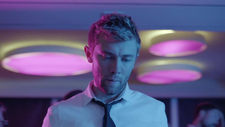 A man looks worried at a party