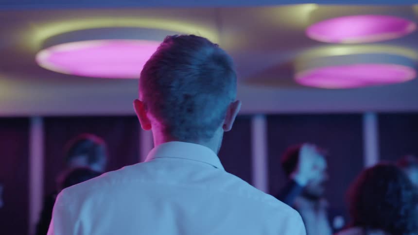 A man looks nervous at a party