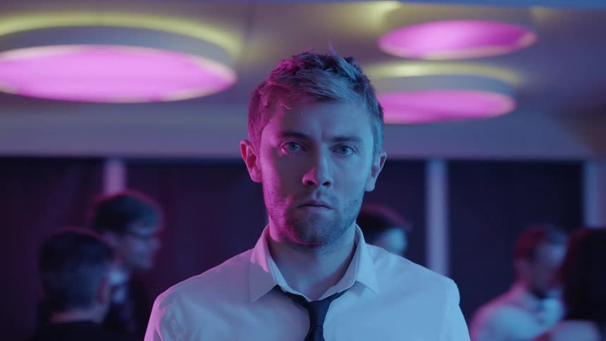 A man looks nervous at a party