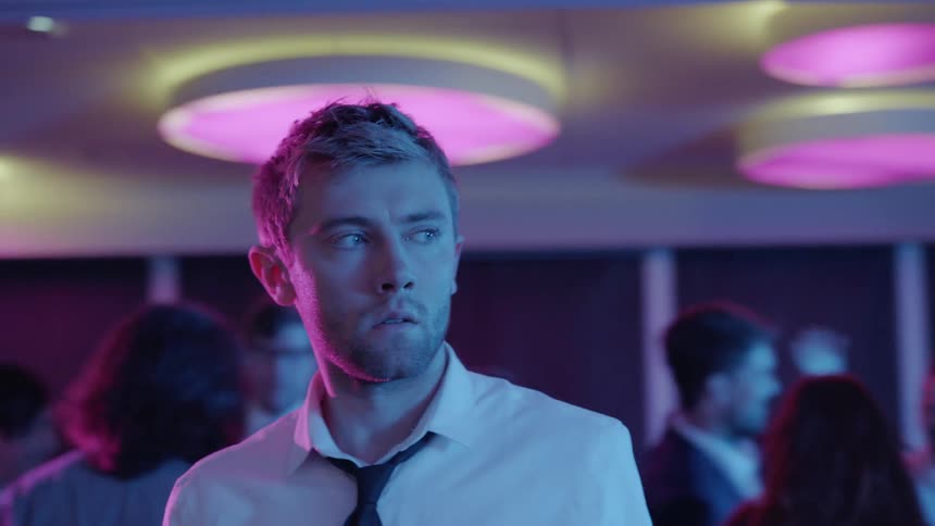 A man standing around in a party
