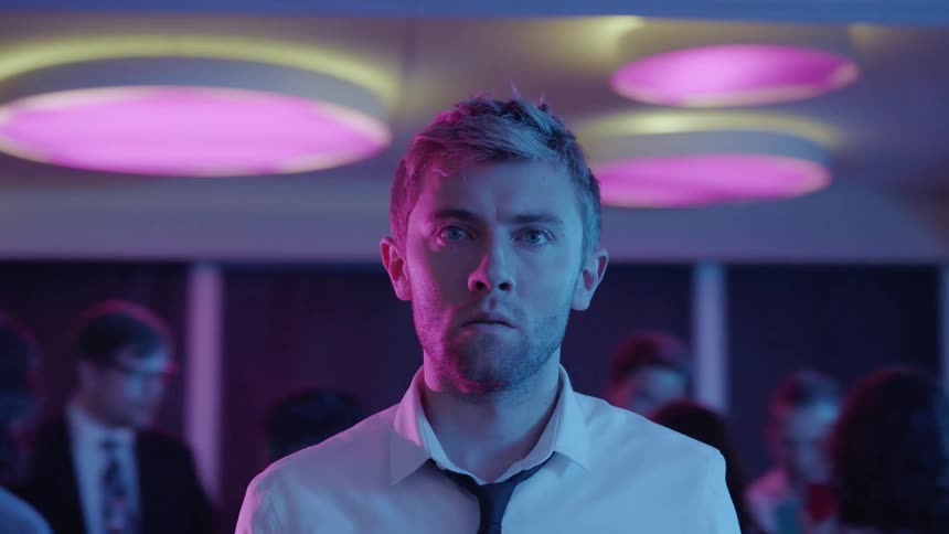 A man looks nervous at a party