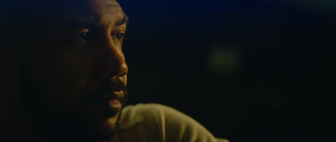 A man looks to the side and blinks