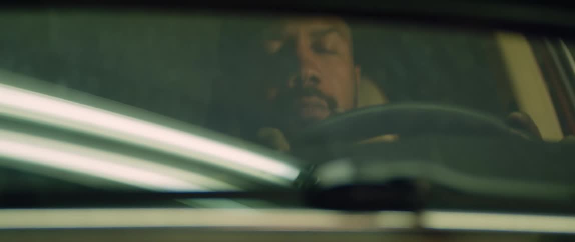 A man is sitting in his car