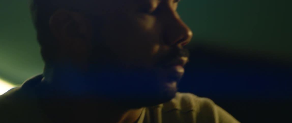 A man looks around a room as he stands up