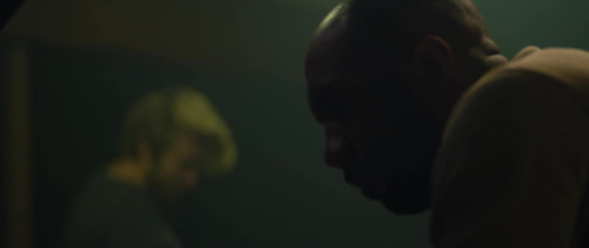Two people walking around in a garage