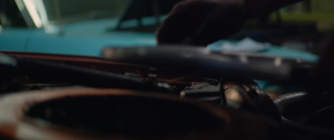 A man is working on a car engine