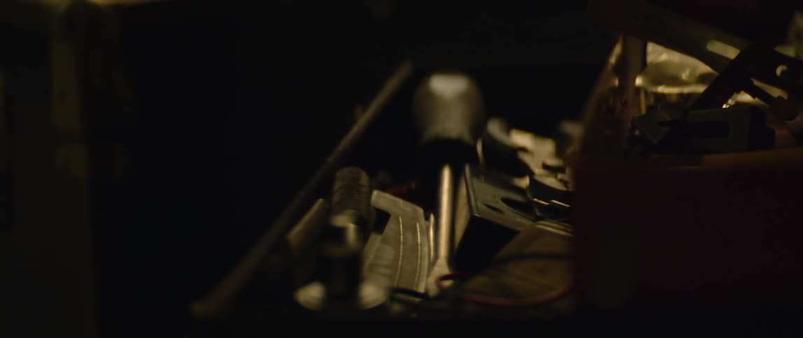 A man closes his toolbox after putting his tools away
