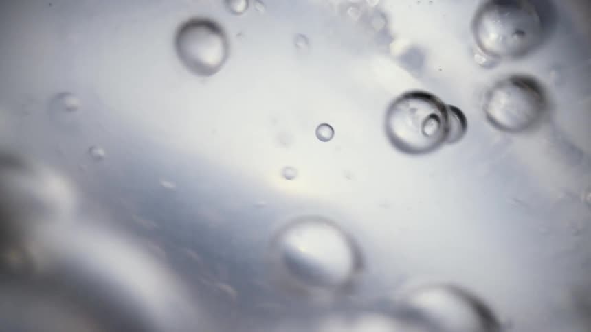 Bubbles form in water under a microscope