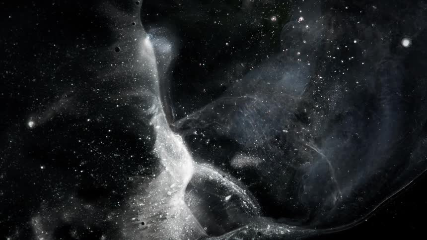 Liquid waves and bubbles in silver and black looking like a starry night