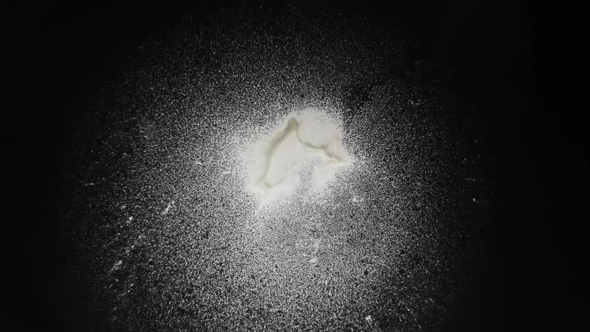 A white liquid explodes into splatters