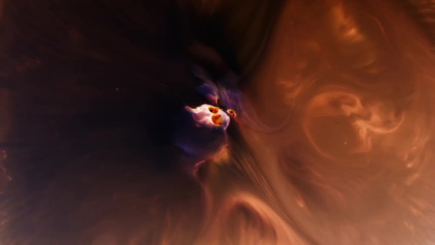 Orange colors move like clouds in the darkness as they emerge from an organic object in the distance