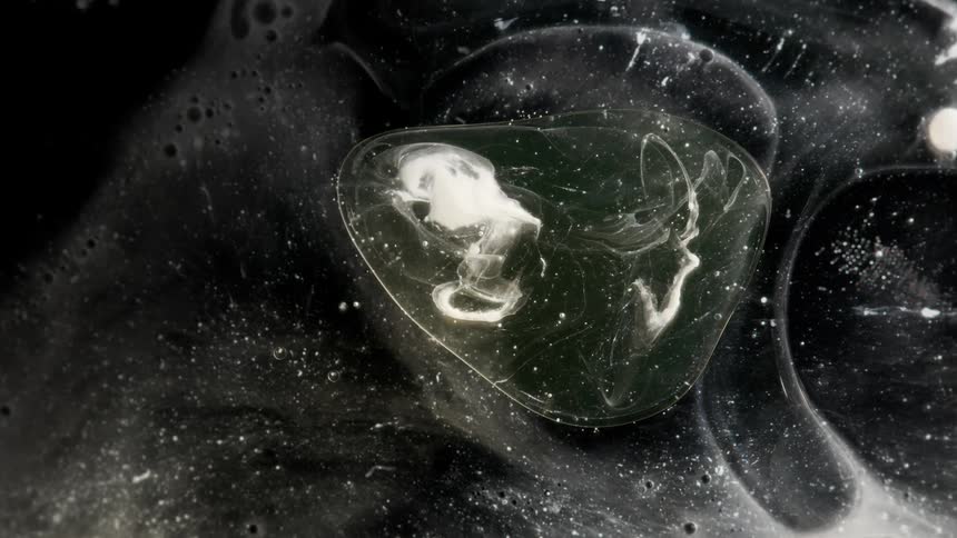 Bubbles filled with a smoky substance move through the night