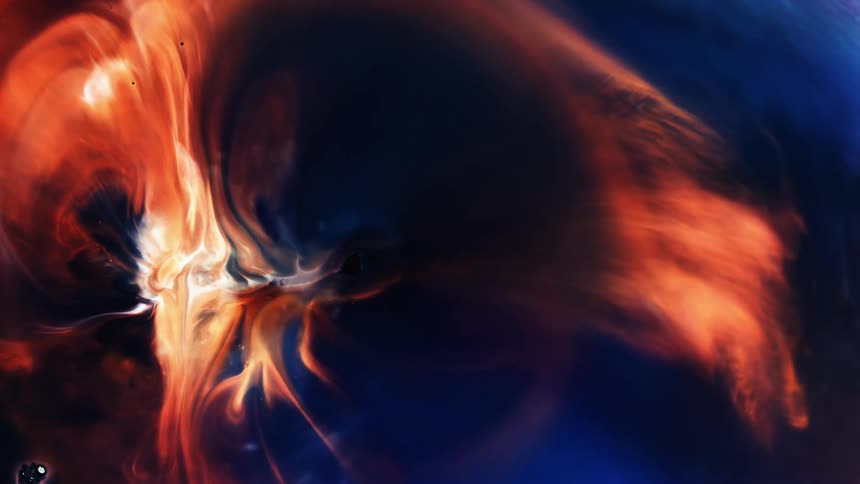 Colorful flames expand and flow from a white hot center