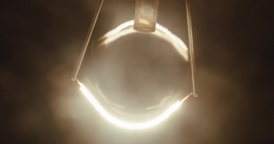 A light comes on glowing in the dark with hazy edges then fades to black