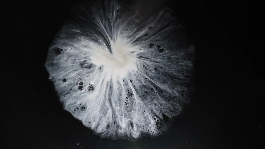 A white liquid explodes outward