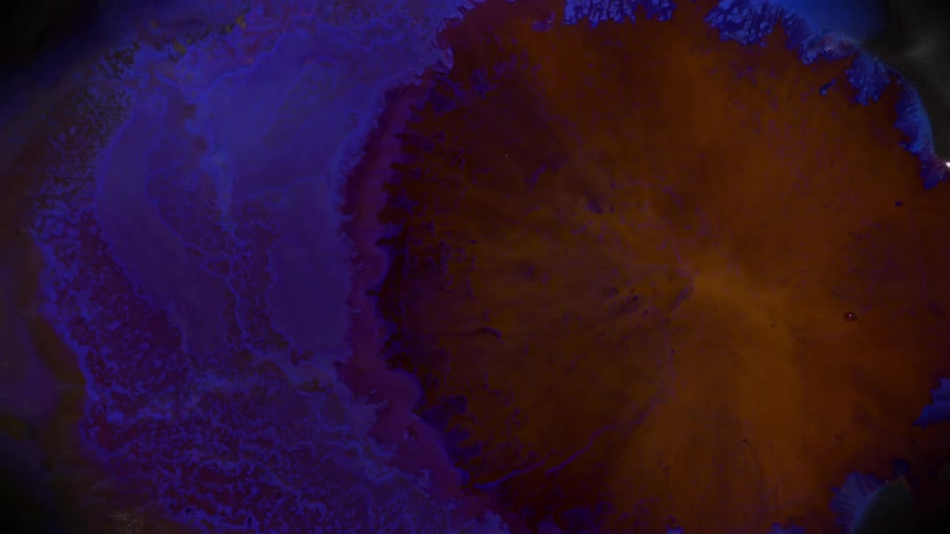 Yellow liquid spreads in the center of the blue liquid