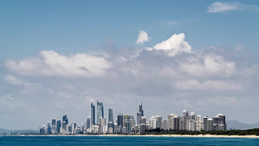 Time lapse view of a downtown city near the ocean is displayed