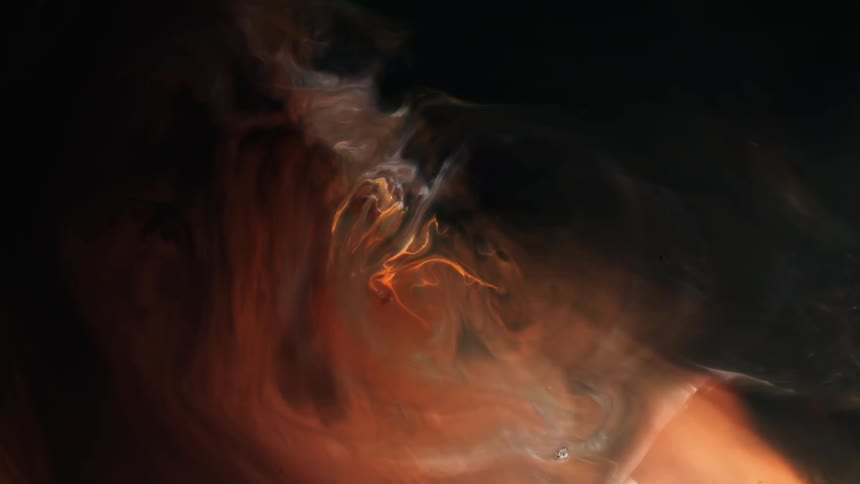 An illuminated organic object is rising from glowing orange smoke