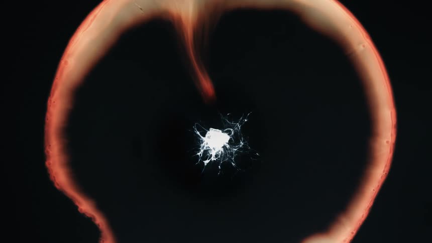 An object explodes with an outer glowing ring and a white center