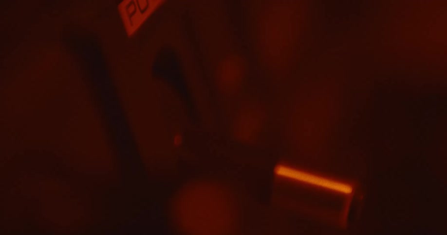 A person flips the switch on an old electronic device