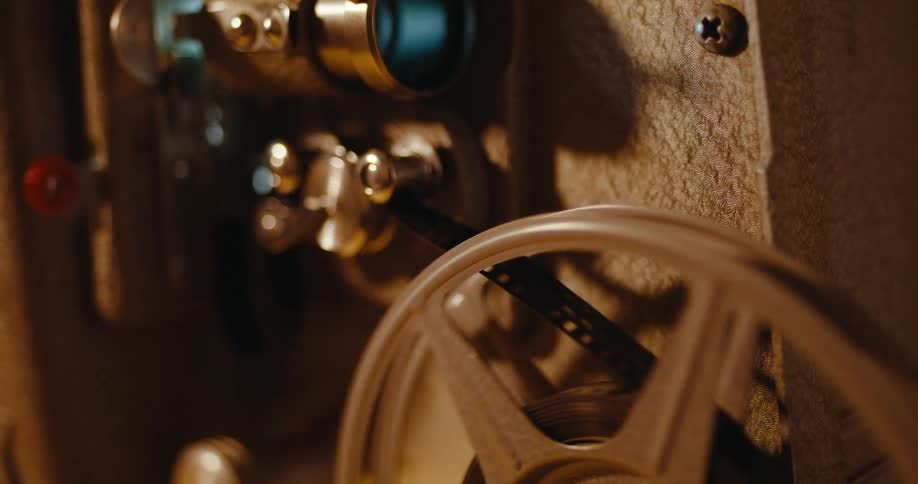 The reel of an old film projector is turning